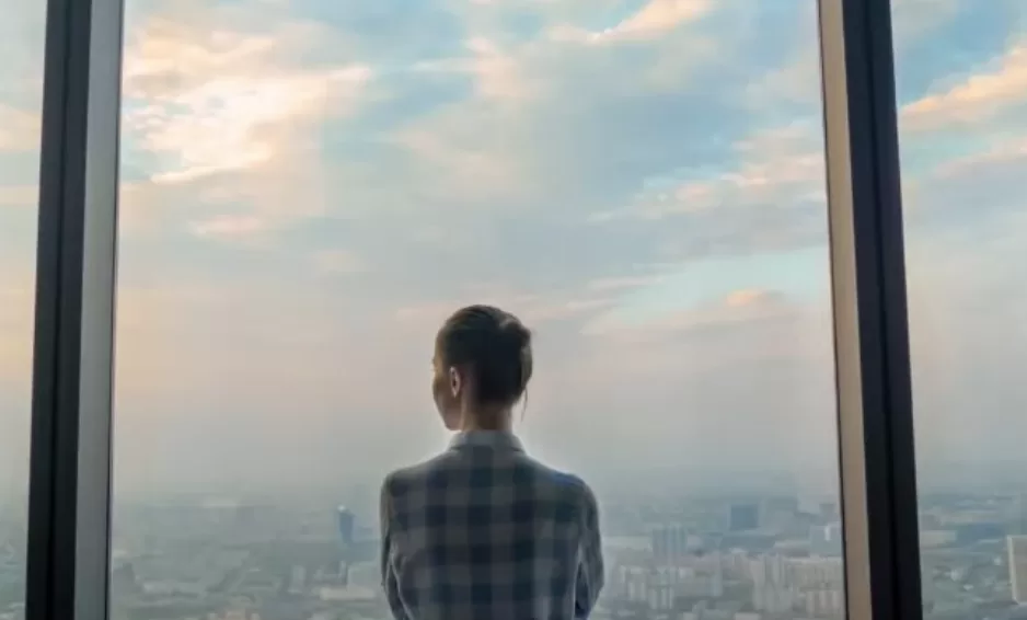 lady thinking about the future in front of a cityscape