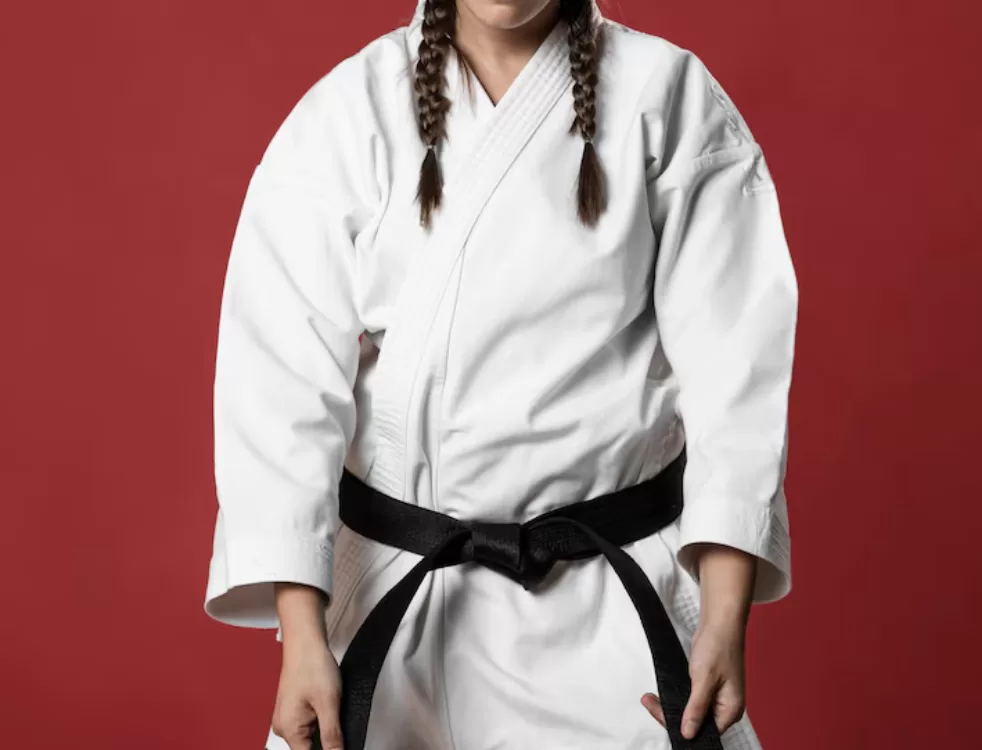 Lady wearing Brazilian jiu-jitsu outfit and black belt