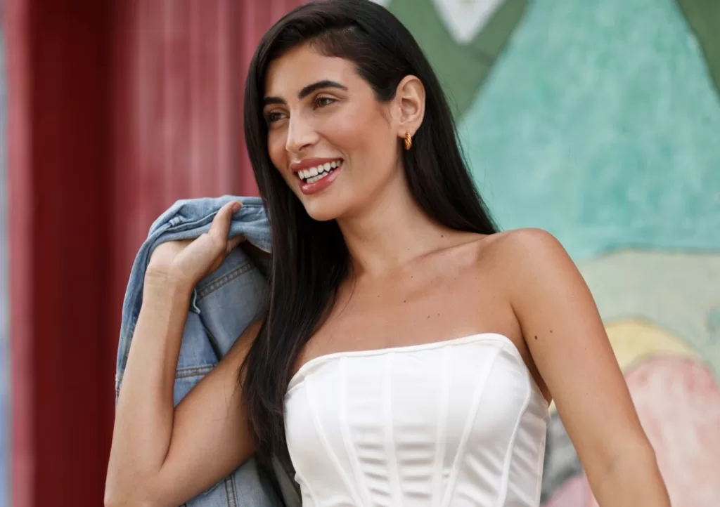 Mexican model smiling with jean jacket over shoulder